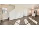 Bright living room features wood-look floors, a staircase, and seamlessly connects to a modern kitchen at 10331 E 62Nd Pl, Denver, CO 80238