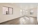 Inviting living room with hardwood floors and plenty of natural light from multiple windows at 10331 E 62Nd Pl, Denver, CO 80238