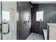 Contemporary bathroom with glass shower featuring gray tile, shower bench, and convenient shower fixtures at 4511 Meade St, Denver, CO 80211