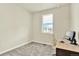 Small bedroom featuring neutral paint, carpet, and a small desk at 11205 W 53Rd Ln, Arvada, CO 80002