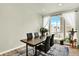 Dining area featuring large windows, a modern table, and stylish chairs at 11205 W 53Rd Ln, Arvada, CO 80002