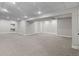 Spacious basement with carpet, drop ceiling, and neutral walls with lighting at 7071 S Gibraltar Way, Centennial, CO 80016