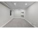 Cozy carpeted basement area featuring a small window and a built-in shelf niche at 7071 S Gibraltar Way, Centennial, CO 80016