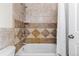 Bathroom features a shower with decorative tile surround, shower head, and shower curtain at 7071 S Gibraltar Way, Centennial, CO 80016
