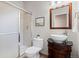 Bathroom featuring a glass door shower and a pedestal sink with a decorative dark wood base at 7071 S Gibraltar Way, Centennial, CO 80016