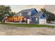 Two-story home features a large backyard, spacious deck with string lights, and an attached two-car garage at 7071 S Gibraltar Way, Centennial, CO 80016