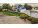 Charming two-story blue home featuring an attached three-car garage, a sprawling lawn, and a delightful outdoor living space at 7071 S Gibraltar Way, Centennial, CO 80016