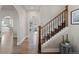 Open-concept hallway with hardwood floors, arched entryways, and access to living spaces at 7071 S Gibraltar Way, Centennial, CO 80016