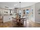 Eat-in kitchen with modern pendant lights and a door to outdoor patio at 7071 S Gibraltar Way, Centennial, CO 80016