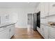 Bright kitchen with stainless steel appliances, granite countertops, and hardwood floors at 7071 S Gibraltar Way, Centennial, CO 80016