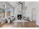 Bright living room with vaulted ceilings, large windows, and fireplace with built-in shelving at 7071 S Gibraltar Way, Centennial, CO 80016