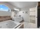 Main bathroom with a jacuzzi tub and a double sink vanity at 7071 S Gibraltar Way, Centennial, CO 80016