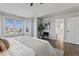 Spacious main bedroom with a hardwood floor, large windows, and access to the main bathroom at 7071 S Gibraltar Way, Centennial, CO 80016