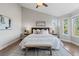 Beautiful main bedroom featuring a large window and a bench at the foot of the bed at 7071 S Gibraltar Way, Centennial, CO 80016