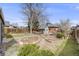 Spacious backyard featuring a well-maintained lawn, raised garden beds, and a cozy outdoor seating area at 4673 Bryant St, Denver, CO 80211