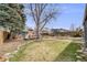 Expansive backyard with lush lawn, patio, mature trees, and meticulous landscaping offers tranquility at 4673 Bryant St, Denver, CO 80211