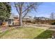 Large backyard with a deck, garden beds, and a well-manicured lawn, perfect for outdoor activities and relaxation at 4673 Bryant St, Denver, CO 80211
