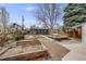 Expansive backyard featuring raised garden beds, a charming deck with seating, and lush greenery at 4673 Bryant St, Denver, CO 80211