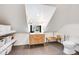 Cozy attic bathroom featuring modern fixtures, wood vanity and neutral tile floors at 4673 Bryant St, Denver, CO 80211