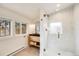Bright bathroom showcasing a modern vanity, glass-enclosed shower, and natural light flooding through the windows at 4673 Bryant St, Denver, CO 80211