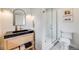 Modern bathroom with sleek vanity, stylish mirror, and glass enclosed shower, complemented by contemporary fixtures at 4673 Bryant St, Denver, CO 80211