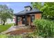 Charming brick home featuring a black trimmed porch and inviting landscaping at 4673 Bryant St, Denver, CO 80211