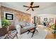 Cozy living room featuring exposed brick, hardwood floors and an open concept floor plan at 4673 Bryant St, Denver, CO 80211