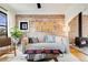 Cozy living room featuring hardwood floors, brick wall and ample natural light at 4673 Bryant St, Denver, CO 80211
