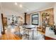 Bright living and dining room featuring hardwood floors and an exposed brick accent wall at 4673 Bryant St, Denver, CO 80211