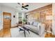 Cozy living room featuring hardwood floors, brick wall and ample natural light at 4673 Bryant St, Denver, CO 80211