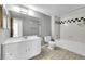 Bathroom with white vanity and tile flooring and bath/shower featuring black and white checkered tile accents at 420 Zang St # 108, Lakewood, CO 80228