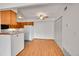 Bright dining area adjacent to kitchen with wood floors, ceiling fan, and ample closet space at 420 Zang St # 108, Lakewood, CO 80228