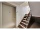 Hallway featuring access to a unit and a stairway with neutral walls and trim at 420 Zang St # 108, Lakewood, CO 80228
