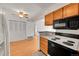 Well-lit kitchen with modern appliances, wood cabinets, and open layout to the dining area at 420 Zang St # 108, Lakewood, CO 80228