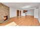 Inviting living room with hardwood floors, stone fireplace, and open access to the kitchen at 420 Zang St # 108, Lakewood, CO 80228
