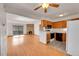 Open-concept living room with hardwood floors, fireplace, and kitchen with modern appliances at 420 Zang St # 108, Lakewood, CO 80228