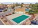 A fenced community pool with a partially covered green surface and surrounding landscape at 420 Zang St # 108, Lakewood, CO 80228
