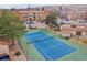 Aerial view of a community tennis court, surrounded by lush landscaping at 420 Zang St # 108, Lakewood, CO 80228