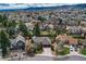 This aerial view showcases the home nestled in a neighborhood with mountain views at 11838 W Arlington Dr, Littleton, CO 80127