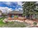 A spacious fenced backyard features a wooden deck, a patio, and mature landscaping at 11838 W Arlington Dr, Littleton, CO 80127