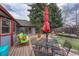 Backyard patio, deck and green space with mature trees at 11838 W Arlington Dr, Littleton, CO 80127