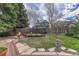 This fenced backyard features a grassy lawn and mature trees at 11838 W Arlington Dr, Littleton, CO 80127