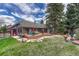 A spacious fenced backyard features a wooden deck, a patio, and mature landscaping at 11838 W Arlington Dr, Littleton, CO 80127