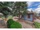 This fenced backyard features gravel landscaping and mature trees at 11838 W Arlington Dr, Littleton, CO 80127