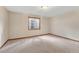 Finished space in basement with neutral carpet, lighting and egress window at 11838 W Arlington Dr, Littleton, CO 80127