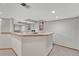 Finished basement featuring a bar, neutral walls, and carpet flooring at 11838 W Arlington Dr, Littleton, CO 80127