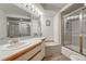 Bathroom with shower, tub, and single vanity with nice mirror and lighting at 11838 W Arlington Dr, Littleton, CO 80127