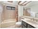 Bathroom featuring a bathtub with a shower, a marble countertop sink, and a toilet at 11838 W Arlington Dr, Littleton, CO 80127