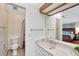 Well-lit bathroom featuring a marble vanity, white cabinets, and a neutral color scheme with shower at 11838 W Arlington Dr, Littleton, CO 80127