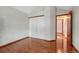 Bedroom with sleek wood floors, white walls, and a sliding door closet at 11838 W Arlington Dr, Littleton, CO 80127